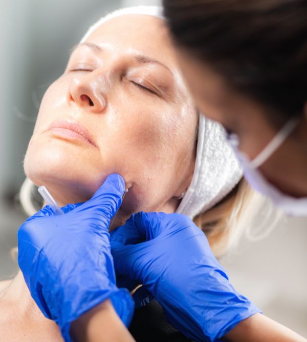 Woman undergoing facial contouring procedure