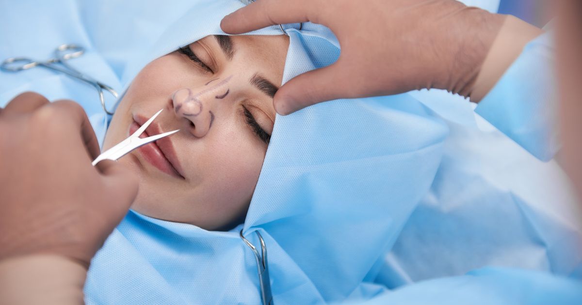 Doctor holding medical tool during rhinoplasty