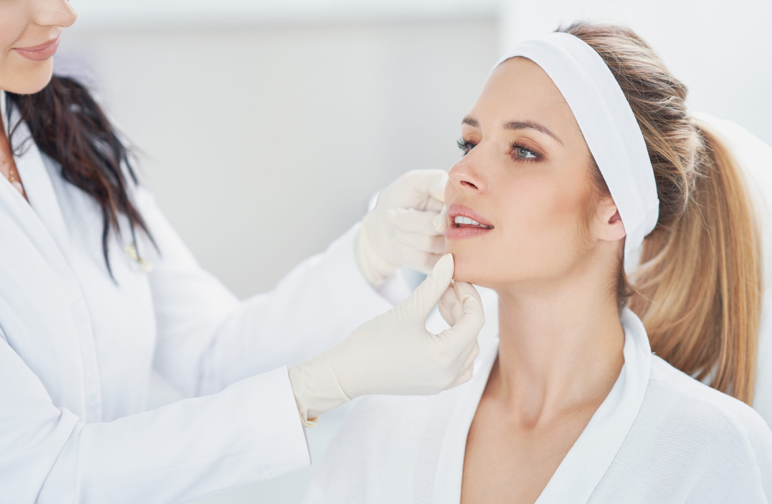 Doctor checking a women's skin for collagen induction therapy