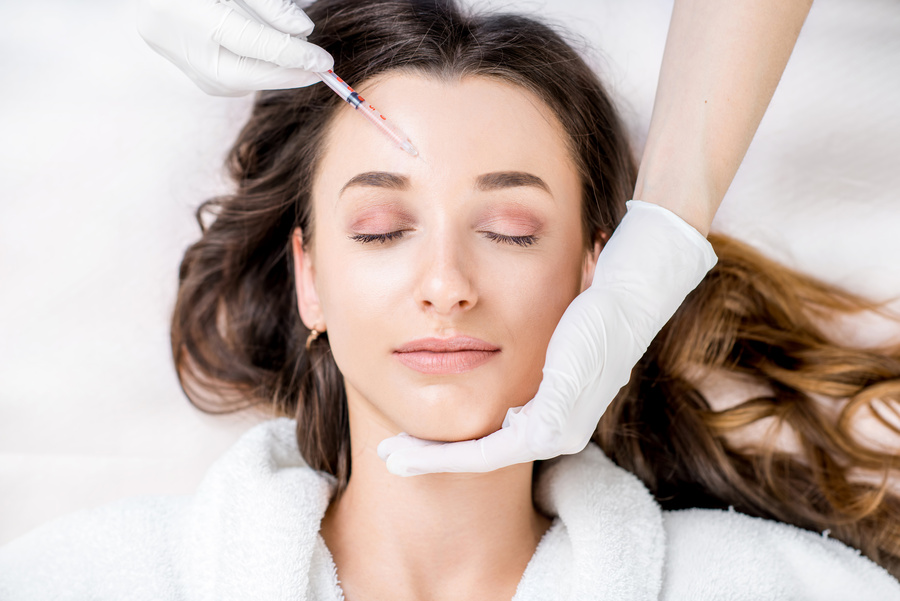 Woman receiving a botox injection in the eye zone